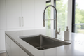 Sleek stainless steel undermount kitchen sink with pull-down faucet